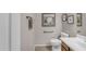 Half bathroom with a white toilet, sink, and framed artwork at 2635 W Angel Way, San Tan Valley, AZ 85144
