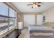 Bright bedroom with a large window offering outdoor views and a ceiling fan at 2635 W Angel Way, San Tan Valley, AZ 85144