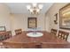 Dining room featuring a chandelier and a large table with seating for eight at 2635 W Angel Way, San Tan Valley, AZ 85144