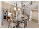 Elegant dining room adjacent to the kitchen, showcasing a chandelier and staircase at 2635 W Angel Way, San Tan Valley, AZ 85144