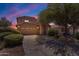 Charming two-story home with desert landscaping, attached two-car garage, and a large shade tree at 2635 W Angel Way, San Tan Valley, AZ 85144