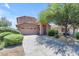 Charming two-story home with desert landscaping, attached two-car garage, and a large shade tree at 2635 W Angel Way, San Tan Valley, AZ 85144