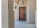 View of the front door with secure metal screen, exterior sconces, and covered porch at 2635 W Angel Way, San Tan Valley, AZ 85144