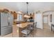 Kitchen with a large island with seating, stainless steel appliances, and wood cabinetry at 2635 W Angel Way, San Tan Valley, AZ 85144