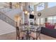 Cozy living room and staircase featuring a fireplace and large windows for natural light at 2635 W Angel Way, San Tan Valley, AZ 85144