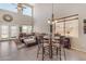 Bright living room with tall ceilings, large windows and comfortable seating arrangements at 2635 W Angel Way, San Tan Valley, AZ 85144