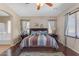 Inviting bedroom with hardwood floors, a plush bed and ensuite bathroom at 2635 W Angel Way, San Tan Valley, AZ 85144