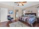 Spacious primary bedroom suite featuring a ceiling fan, wood floors, and a sitting area at 2635 W Angel Way, San Tan Valley, AZ 85144