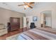 Comfortable main bedroom with wood floors, closet, ensuite bathroom, and a decorative area rug at 2635 W Angel Way, San Tan Valley, AZ 85144
