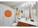 Modern bathroom features a vanity with wood cabinets and decorative shower curtain with orange circle at 2724 S Chaparral Rd, Apache Junction, AZ 85119