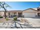 Charming single-story home with desert landscaping, covered porch, and attached two-car garage at 2724 S Chaparral Rd, Apache Junction, AZ 85119