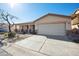 Charming home exterior features a well-manicured front yard, a wide driveway, and a two-car garage at 2724 S Chaparral Rd, Apache Junction, AZ 85119