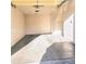 A single car garage featuring concrete floors, overhead lighting, and an automatic door opener at 295 N Rural Rd # 259, Chandler, AZ 85226