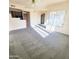 Open-concept living room featuring carpeting, a ceiling fan, and natural light from the window at 295 N Rural Rd # 259, Chandler, AZ 85226