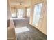 Sunlit living room with plush carpeting, ceiling fan, and sliding glass door to the outside at 295 N Rural Rd # 259, Chandler, AZ 85226