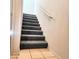 Carpeted stairway with white walls and handrail that leads to the upper level of the home at 295 N Rural Rd # 259, Chandler, AZ 85226