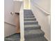 Carpeted stairs with white handrails lead to the upper level of the home at 295 N Rural Rd # 259, Chandler, AZ 85226