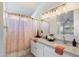 Bright bathroom with dual sinks, modern fixtures, and a shower-tub combination, offering convenience and style at 30420 N 43Rd St, Cave Creek, AZ 85331