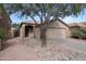 Inviting home with desert landscaping, a large shade tree, and a two-car garage offering practical and aesthetic appeal at 30420 N 43Rd St, Cave Creek, AZ 85331