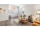Comfortable living room featuring wood-look floors, a neutral color palette, and large windows for natural light at 30420 N 43Rd St, Cave Creek, AZ 85331