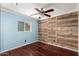 Charming bedroom features a striking wood accent wall and a window for natural light at 3135 W Echo Ln, Phoenix, AZ 85051