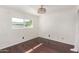 Bedroom with hardwood floors, neutral walls, crown molding, and natural light at 3135 W Echo Ln, Phoenix, AZ 85051