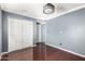 Spacious bedroom with gray-blue walls and double door closet for ample storage at 3135 W Echo Ln, Phoenix, AZ 85051