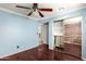 Light-filled bedroom with blue walls, polished wood floors, and a mirrored sliding closet at 3135 W Echo Ln, Phoenix, AZ 85051