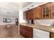 The kitchen features wood cabinets, stone countertops, white appliances, and views into the living room at 3135 W Echo Ln, Phoenix, AZ 85051