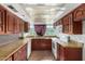 This kitchen has tile counters, wood cabinets, white appliances and a window at 3135 W Echo Ln, Phoenix, AZ 85051