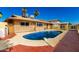 Backyard pool surrounded by a concrete patio offers a serene outdoor space for leisure and recreation at 3135 W Echo Ln, Phoenix, AZ 85051