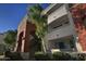 Exterior view of a building with brick accents, balconies, and landscaping, under a blue sky at 3302 N 7Th St # 239, Phoenix, AZ 85014