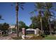 Community sign for Brick Commons with palm trees and landscaping, under a clear blue sky at 3302 N 7Th St # 239, Phoenix, AZ 85014