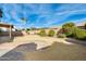 A backyard that features a rock border, drought resistant landscaping, and palm trees at 3752 W Alameda Rd, Glendale, AZ 85310