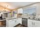 Bright kitchen features granite counters, white cabinets, stainless steel appliances, and views of the living spaces at 3752 W Alameda Rd, Glendale, AZ 85310