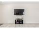 Contemporary living room with tile flooring, a mounted TV, and subtle decor at 3804 W Ashton Dr, Anthem, AZ 85086