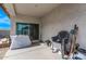 The back patio has neutral toned concrete and stucco, and a sliding glass door at 4051 S 243Rd Dr, Buckeye, AZ 85326