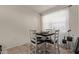 Cozy dining area featuring a modern table with seating for four near a bright window at 4051 S 243Rd Dr, Buckeye, AZ 85326