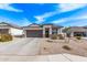 Inviting one-story home with desert landscaping, a two-car garage, and a covered front entry at 4051 S 243Rd Dr, Buckeye, AZ 85326