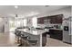 Open-concept kitchen with granite island, stainless appliances, and seamless flow to the living area at 4051 S 243Rd Dr, Buckeye, AZ 85326