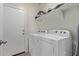 The laundry room features a modern washer and dryer with shelving above at 4051 S 243Rd Dr, Buckeye, AZ 85326