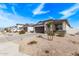 Quiet street featuring a row of well-kept single-Gathering homes with desert-friendly landscaping at 4051 S 243Rd Dr, Buckeye, AZ 85326