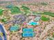 Stunning aerial view of a golf course community with tennis courts, pool, and lush landscaping at 41309 N Belfair Way, Anthem, AZ 85086