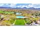 Scenic aerial view of a pool, golf course, and well-kept lawns against a mountain backdrop at 41309 N Belfair Way, Anthem, AZ 85086