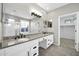 Elegant bathroom featuring dual sinks, granite countertops, and a separate glass-enclosed shower at 41309 N Belfair Way, Anthem, AZ 85086