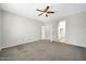 Spacious primary bedroom with ensuite bathroom and neutral carpeting and ceiling fan at 41309 N Belfair Way, Anthem, AZ 85086