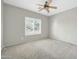 Bedroom showcasing plantation shutters, neutral walls and carpet, and a ceiling fan at 41309 N Belfair Way, Anthem, AZ 85086