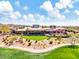 Expansive clubhouse with beautiful desert landscaping and lush green lawns under a partly cloudy blue sky at 41309 N Belfair Way, Anthem, AZ 85086