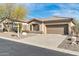 Charming single-story home with a desert landscape, tile roof and a two-car garage at 41309 N Belfair Way, Anthem, AZ 85086