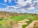 Beautiful view of a lush golf course surrounded by desert landscape and mountains at 41309 N Belfair Way, Anthem, AZ 85086
